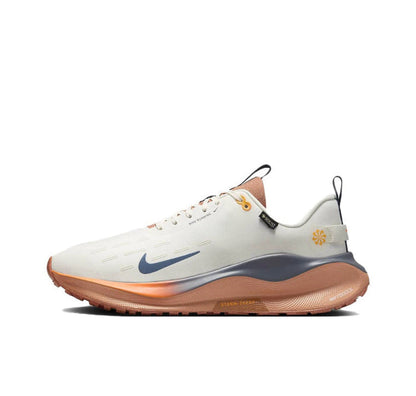 Nike Infinity RN 4 Gore-Tex running shoe, cream upper with blue swoosh, orange outsole