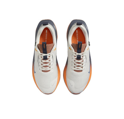 Nike Gore-Tex running shoes, cream uppers with white laces and blue heel accents
