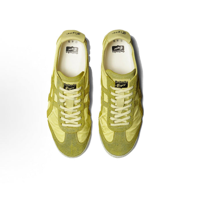 Pair of light chartreuse low-top sneakers with lace-up front and textured side panels