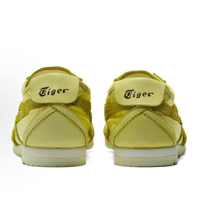 Back view of light chartreuse low-top sneakers with heel pull tabs and padded collars