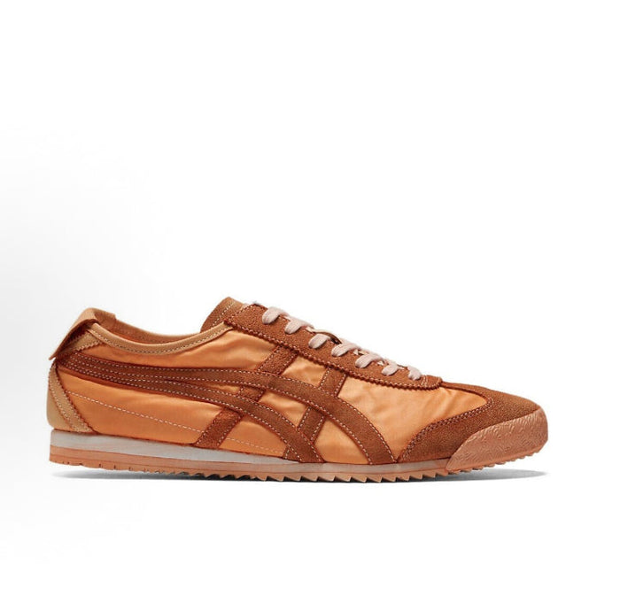 Low-top sneaker side view in orange-brown suede with patterned midsole