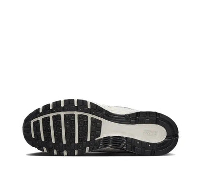 White running sneaker outsole with black traction tread and cushioned midsole