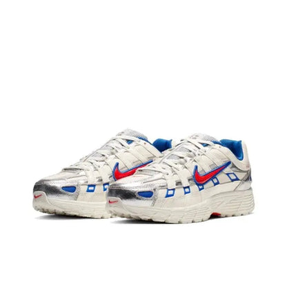 Premium running sneaker side view, white upper with blue geometric overlays and red swoosh