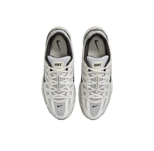 White Nike running sneaker with lace-up front and mesh upper