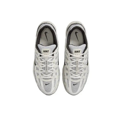 White Nike running sneaker with lace-up front and mesh upper