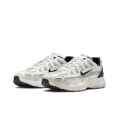 White-and-black lace-up running sneakers with cushioned, ribbed midsole