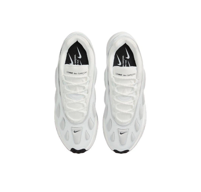 Pair of white sneakers with Nike swooshes and black heel lining