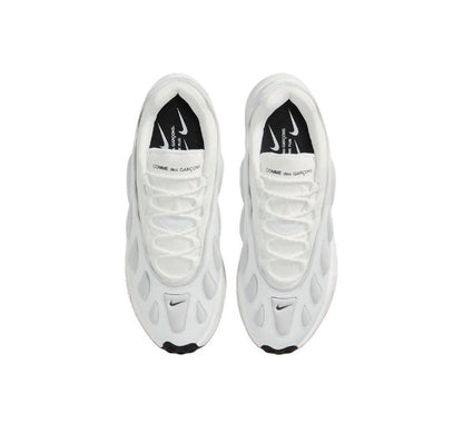 Pair of white sneakers with Nike swooshes and black heel lining