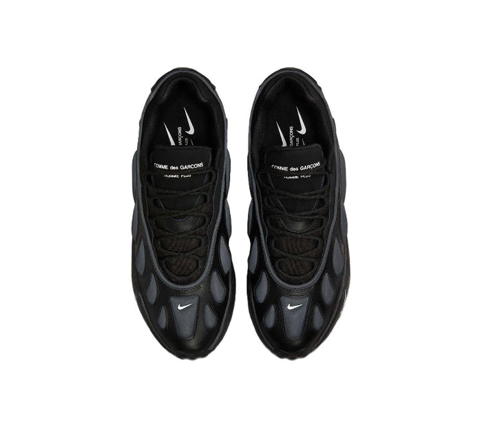 Pair of black Nike sneakers top view with laces and tongue branding