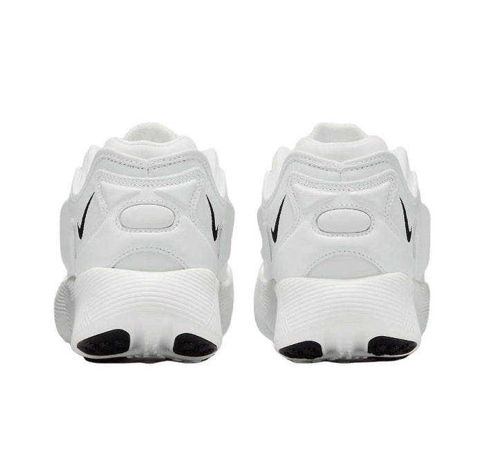 White low-top sneakers with Nike swooshes and dark heel pull tabs