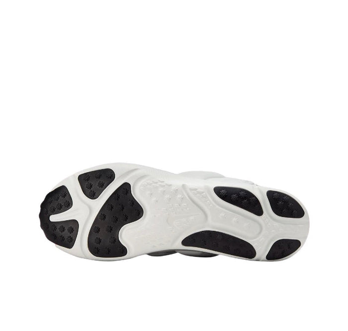 White rubber outsole with black traction pods and sculpted grooves