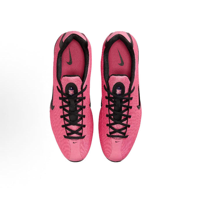 Pink lace-up running shoes showing inner heel and tongue with black trims