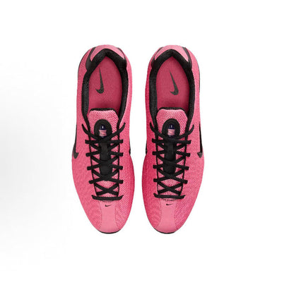Pink lace-up running shoes showing inner heel and tongue with black trims