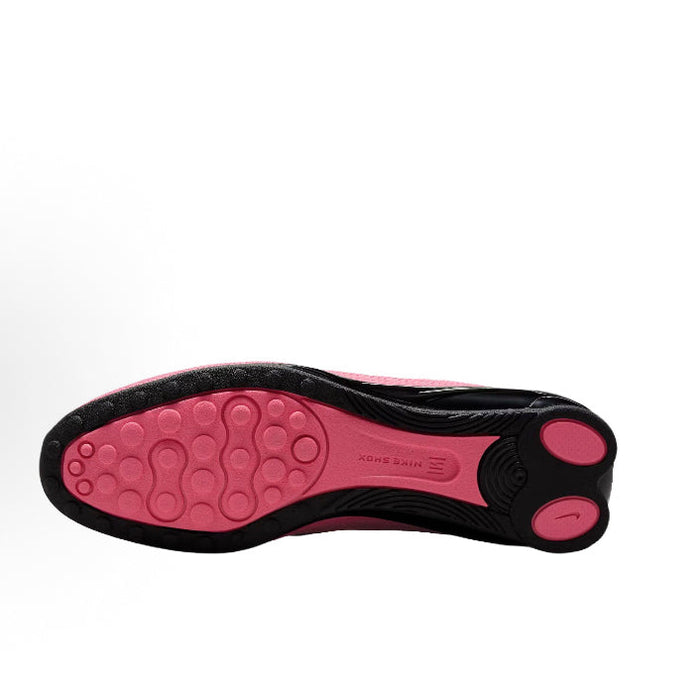 Pink and black rubber outsole with traction pods and circular traction details