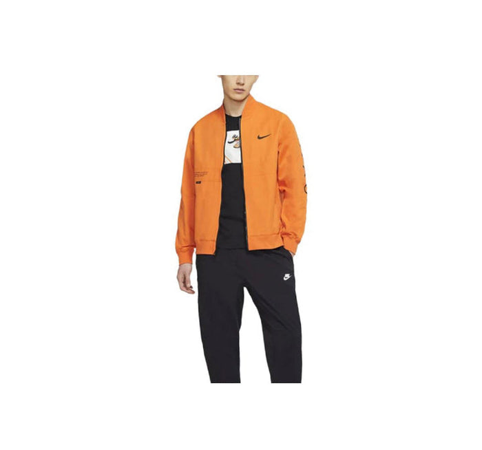 Orange Nike windbreaker jacket with full-zip front, worn over black top