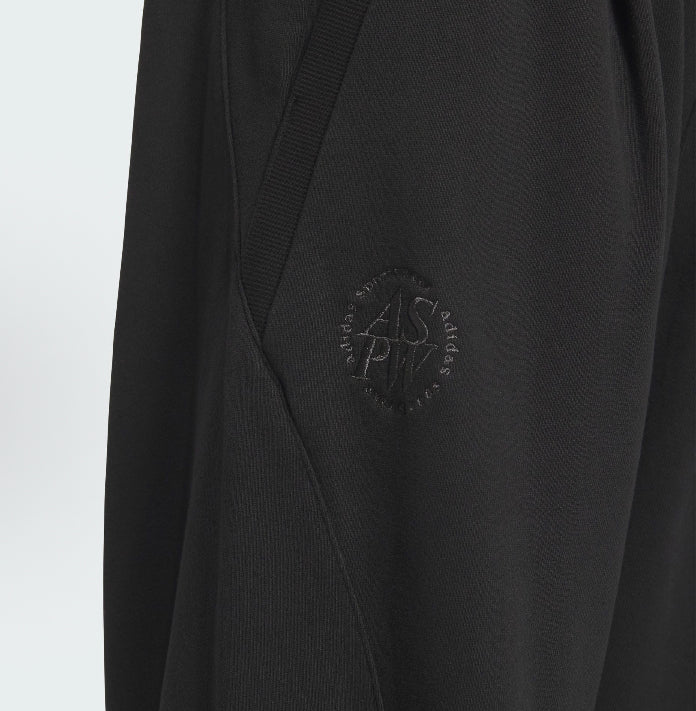 Black track pants with embossed adidas mark on side panel