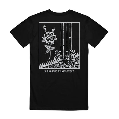Black I Am The Avalanche Comfort Colors t-shirt featuring a white back graphic with a rose, two pitchfork shapes above it, vertical lines, waves, and "I AM THE AVALANCHE" text at the bottom.