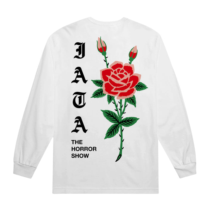 This white long-sleeve Comfort Colors tee by I Am The Avalanche features a large red rose and buds on the back, with black Gothic "JATA" text vertically and "THE HORROR SHOW" in smaller capitals below.