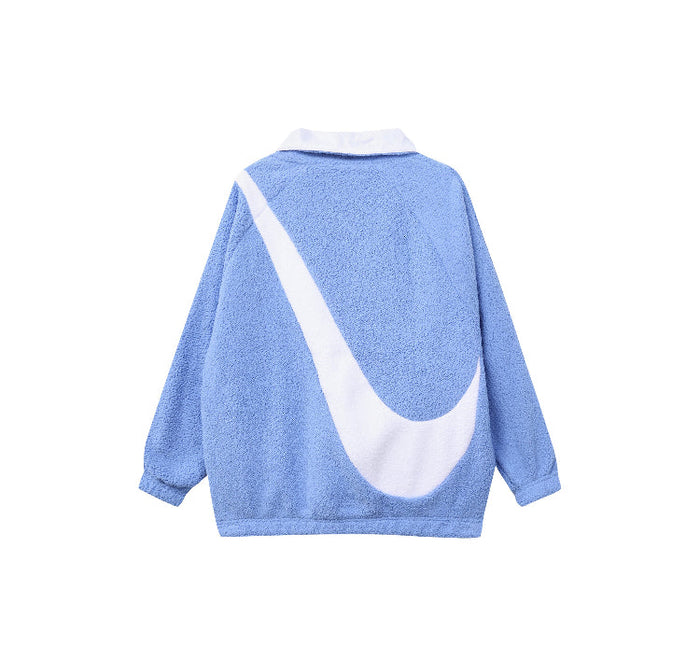 Nike reversible velvet jacket back view in light blue with large white swoosh