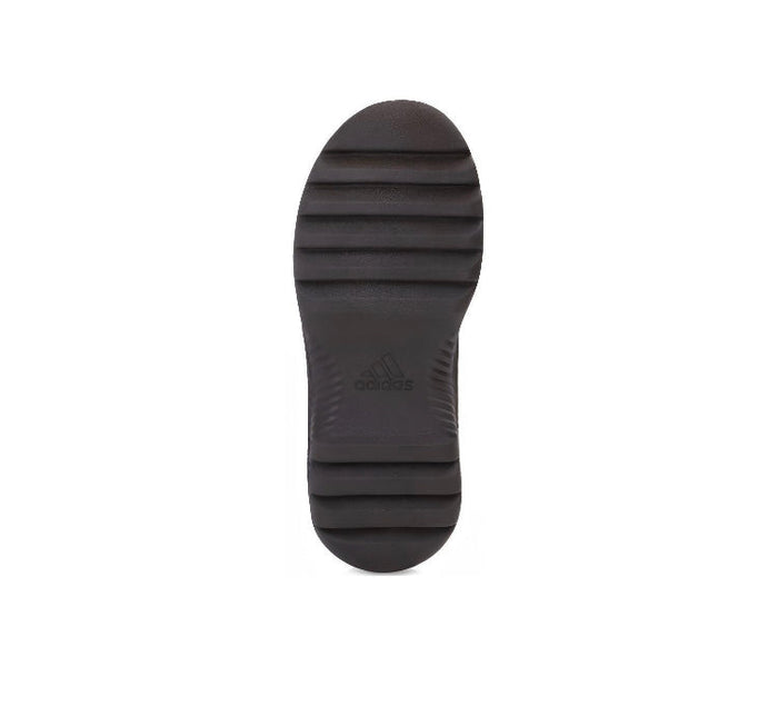 Dark brown boot outsole with tread pattern and Adidas logo
