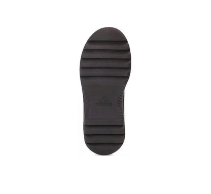 Dark brown boot outsole with tread pattern and Adidas logo