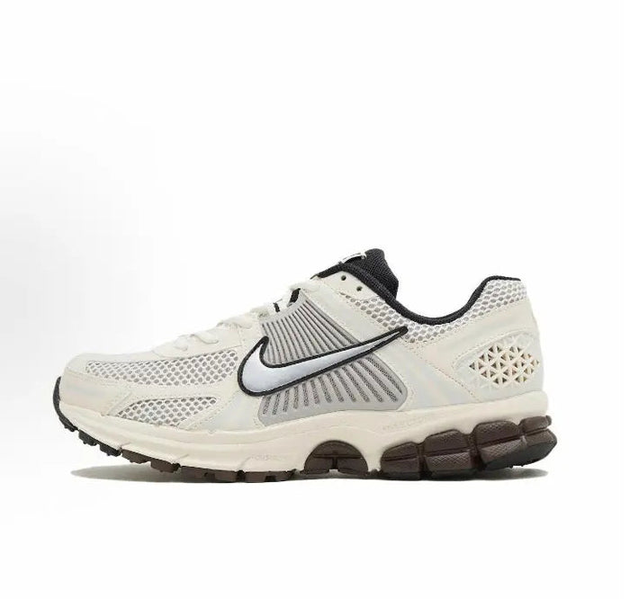 Nike running shoes: white mesh upper, black swoosh, and dark rubber heel pods