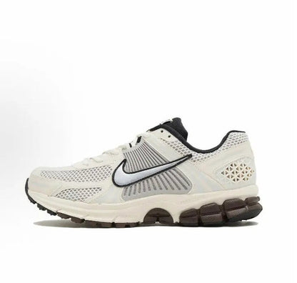 Nike running shoes: white mesh upper, black swoosh, and dark rubber heel pods