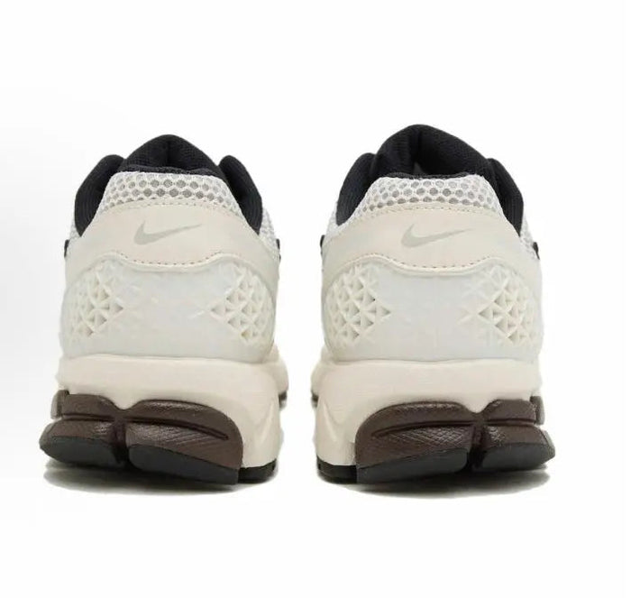 Nike running shoes: white heel and back panels with black collar lining