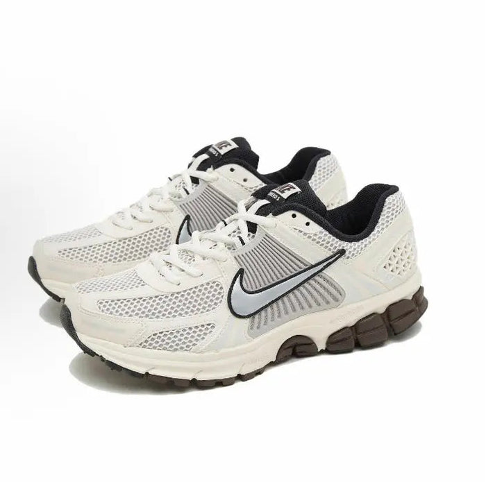 Nike running shoes: white/cream mesh upper with black swoosh and lace-up design