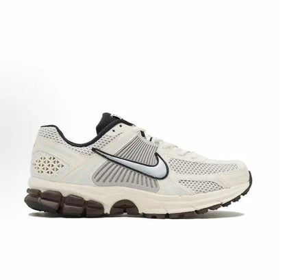 Nike running shoes: side view of white upper with black swoosh and ribbed detail
